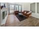 Bright living room featuring hardwood floors, a fireplace, and large windows at 9806 Hooker Ct, Denver, CO 80031