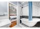 Renovated bathroom featuring tiled floors, a blue shower curtain, and entry into a bedroom at 3254 Newton St, Denver, CO 80211