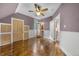 Bedroom with hardwood floors, a ceiling fan, unique door trim, and an ensuite bathroom view at 3254 Newton St, Denver, CO 80211