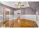 Spacious bedroom featuring hardwood floors, a ceiling fan, and access to an ensuite bathroom and additional storage space at 3254 Newton St, Denver, CO 80211
