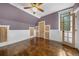 A charming bedroom featuring natural light, hardwood floors and unique door trim details at 3254 Newton St, Denver, CO 80211