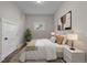 A well-lit bedroom with neutral tones, complemented by a cozy rug and minimalist decor at 3254 Newton St, Denver, CO 80211