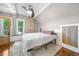 Cozy bedroom with natural light, a ceiling fan, exposed brick, and hardwood floors topped with a plush rug at 3254 Newton St, Denver, CO 80211
