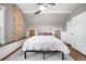 Bright bedroom featuring a ceiling fan, exposed brick, hardwood floors with a plush rug and ample natural light at 3254 Newton St, Denver, CO 80211
