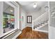 Inviting entryway with hardwood floors, white trim, and a staircase leading to the upper level at 3254 Newton St, Denver, CO 80211