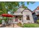 Charming home with a quaint front porch, outdoor seating, and well-maintained landscaping at 3254 Newton St, Denver, CO 80211