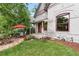 Charming home exterior with landscaped front yard, patio, and mature trees providing shade at 3254 Newton St, Denver, CO 80211