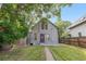Charming two-story home with gray siding, a well-manicured front yard, and a purple front door at 3254 Newton St, Denver, CO 80211