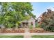 Charming exterior view of a well-maintained two-story home with mature trees and manicured landscaping at 3254 Newton St, Denver, CO 80211