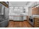 Well-lit kitchen with white cabinets, stainless steel appliances, hardwood floors, and subway tile backsplash at 3254 Newton St, Denver, CO 80211