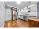 Open kitchen showcases white cabinetry, butcher block counters, stainless appliances, and beautiful hardwood flooring at 3254 Newton St, Denver, CO 80211