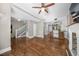 Open-concept living space with hardwood floors, white trim, and access to the kitchen and staircase at 3254 Newton St, Denver, CO 80211
