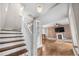 Inviting living room with a brick fireplace and hardwood floors, leading to a staircase at 3254 Newton St, Denver, CO 80211