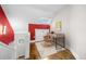Upper level landing with a modern desk area, lit by a window and an accent wall at 3254 Newton St, Denver, CO 80211