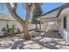 Landscaped backyard with new fence, rock bed, mulch, trees, and open-air structure at 4350 S Delaware St, Englewood, CO 80110