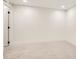 Finished basement features new neutral carpet, fresh paint, and updated lighting at 4350 S Delaware St, Englewood, CO 80110