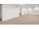 Spacious basement featuring neutral carpet, bright lighting, and ample room for living or storage at 4350 S Delaware St, Englewood, CO 80110