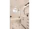 Stylish bathroom with black hardware, subway tile shower, patterned tile floors, and ample vanity storage at 4350 S Delaware St, Englewood, CO 80110