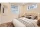 Comfortable bedroom featuring a tufted headboard, soft bedding, and bright natural light at 4350 S Delaware St, Englewood, CO 80110