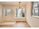 Inviting entryway with bay window, modern chandelier, and a stylish front door at 4350 S Delaware St, Englewood, CO 80110
