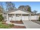 Charming home featuring a well-maintained front yard, a covered parking area, and a classic white exterior at 4350 S Delaware St, Englewood, CO 80110