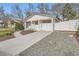 Well-manicured front yard with a concrete walkway, complementing the classic white exterior with covered parking at 4350 S Delaware St, Englewood, CO 80110