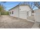 Detached garage with white siding, two bay doors, and a concrete driveway and entrance at 4350 S Delaware St, Englewood, CO 80110