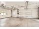 Bright and large garage area with two white doors, white walls, and concrete floor at 4350 S Delaware St, Englewood, CO 80110