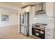 Modern kitchen featuring stainless steel appliances, sleek cabinetry, and a stylish tile backsplash at 4350 S Delaware St, Englewood, CO 80110