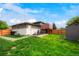 Spacious backyard featuring a patio with seating, a lush lawn, and a detached storage shed at 6163 W 76Th Ave, Arvada, CO 80003