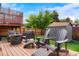 Charming backyard patio with a fire pit, comfortable seating, and a lush green lawn at 6163 W 76Th Ave, Arvada, CO 80003