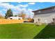 Large backyard with a well-maintained artificial turf, hot tub, RV, and a wooden fence at 6163 W 76Th Ave, Arvada, CO 80003