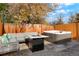 Backyard patio with hot tub, fire pit, and comfortable lounge seating at 6163 W 76Th Ave, Arvada, CO 80003