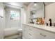 Bathroom with a white vanity, a large mirror, and a shower-tub combination at 6163 W 76Th Ave, Arvada, CO 80003