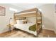 Cozy bedroom with a bunk bed, a table with a lamp, and a decorative rug at 6163 W 76Th Ave, Arvada, CO 80003