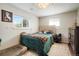 Comfortable bedroom with a decorative headboard, soft bedding, and hardwood floors at 6163 W 76Th Ave, Arvada, CO 80003