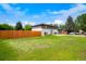 Charming two-story home featuring a spacious front yard and a stained wooden fence at 6163 W 76Th Ave, Arvada, CO 80003