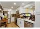 Modern kitchen with stainless steel appliances, white cabinets, and quartz countertops at 6163 W 76Th Ave, Arvada, CO 80003