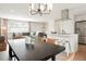 Inviting open concept showcases an island kitchen flowing into the living and dining area, perfect for modern living at 6163 W 76Th Ave, Arvada, CO 80003