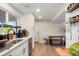 This kitchen is bright and equipped with stainless steel appliances and a dining table for a seamless cooking and dining experience at 6163 W 76Th Ave, Arvada, CO 80003