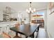 Open concept kitchen and dining area with stainless steel appliances and access to the outdoor deck at 6163 W 76Th Ave, Arvada, CO 80003