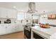 Modern kitchen with stainless appliances, a functional island, and seamless access to the inviting outdoor deck at 6163 W 76Th Ave, Arvada, CO 80003