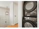 Conveniently located, a compact laundry area features a stacked washer and dryer set at 6163 W 76Th Ave, Arvada, CO 80003