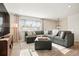 Comfortable living room features a large sectional sofa and ample natural light at 6163 W 76Th Ave, Arvada, CO 80003