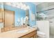Bathroom featuring blue walls, a granite vanity, and a shower with a glass door at 10152 Telluride St, Littleton, CO 80125