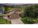 Charming home featuring a two-car garage and mountain views in a well-manicured, green lawn at 10152 Telluride St, Littleton, CO 80125