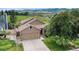 Charming home exterior with a two-car garage, mature trees, and a well-maintained lawn at 10152 Telluride St, Littleton, CO 80125