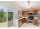 Functional kitchen with stainless steel appliances and sliding doors opening to the backyard at 10152 Telluride St, Littleton, CO 80125