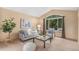 Sunlit living room features neutral tones and a large window with views of lush trees at 10152 Telluride St, Littleton, CO 80125