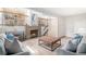 Comfortable living room with a brick fireplace and a view of the upper level at 10152 Telluride St, Littleton, CO 80125